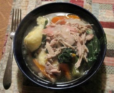 turkey soup in a black bowl